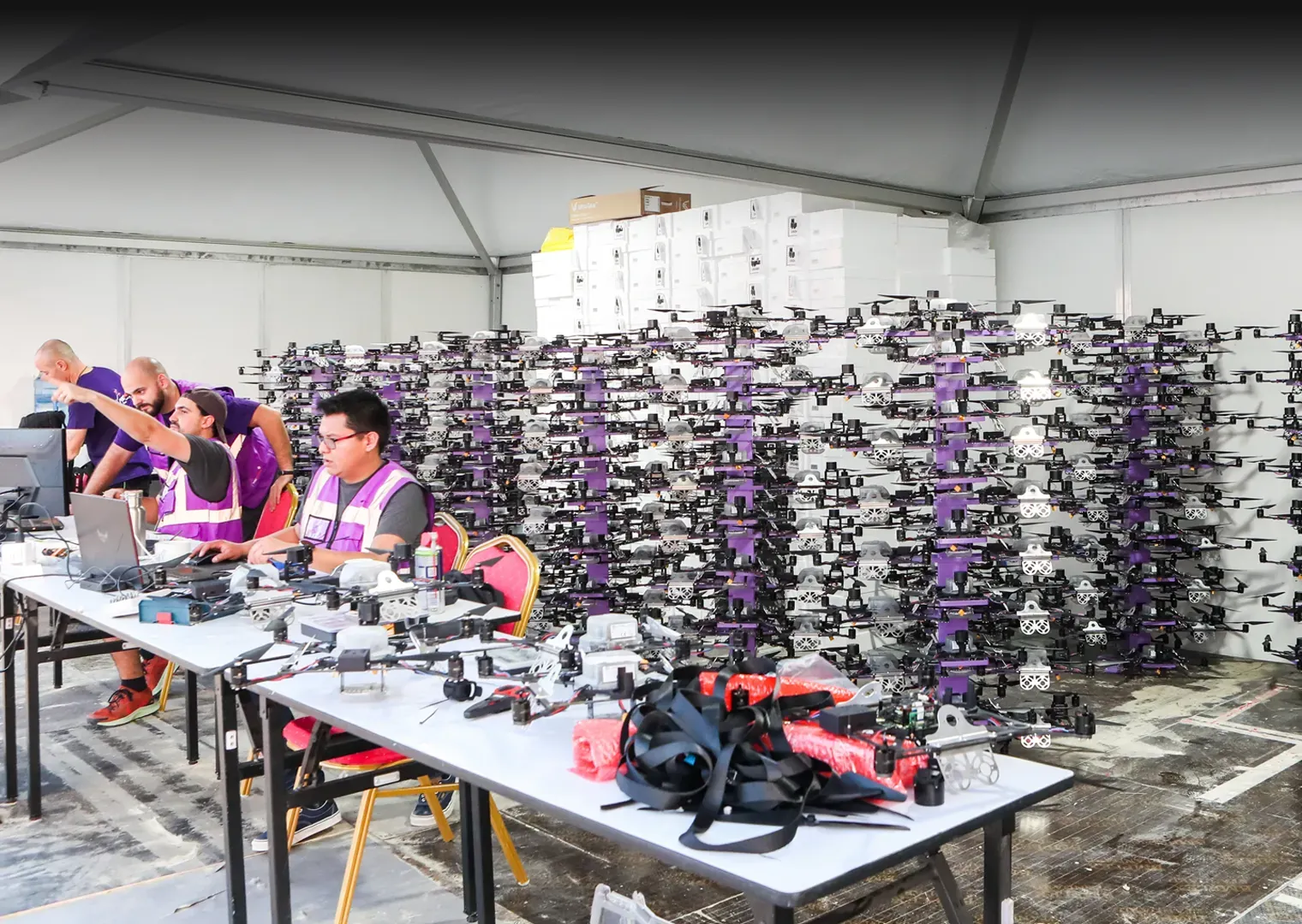 Team preparing pyrotechnic drones in the backstage